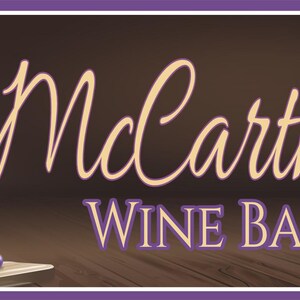 Personalized wine bar sign with red wine bottle, cheese wedge, grapes, and custom name