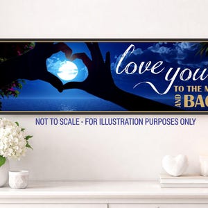 love you to the moon and back wall sign displayed above console table in soft neutral home setting