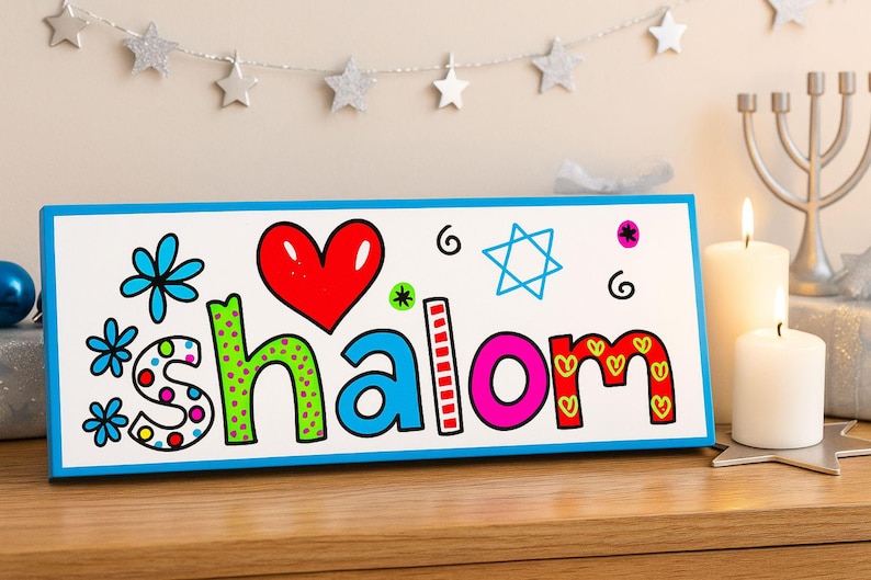 Shalom sign leaning against festive décor in a Jewish-inspired holiday setting with blue, white, and silver garlands, candles, and star accents.
