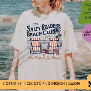 May include: A white t-shirt with a graphic design of two beach chairs with books on them. The text "Salty Readers Beach Club" is above the chairs and "Plot Twists & Sea Breezes" is below.