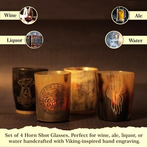 May include: Four horn shot glasses with Viking-inspired hand engravings. Suitable for wine, ale, liquor, or water. Each glass has a unique design and colour. The text says: Set of 4 Horn Shot Glasses.