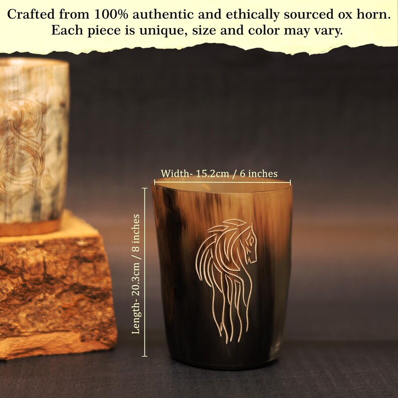 May include: An ox horn drinking cup with a horse design etched on the side. The cup is 20.3cm tall and 15.2cm wide. The horn has a natural colour gradient from light brown to black.