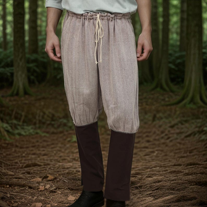 May include: A pair of brown and white patterned pants with a drawstring waist and dark brown cuffs. The pants are made of a soft, textured fabric.