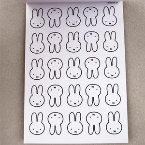 May include: A sheet of stickers featuring a repeating pattern of black and white cartoon bunny faces. Each bunny has long ears, a small nose, and a simple bow tie. The stickers are on a white background.