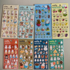 May include: Eight vertical sheets of Miffy puffy stickers featuring various colourful illustrations of the rabbit character, including animals, fruits, musical notes, and stars, all displayed on individual branded cardboard backing cards.
