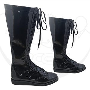 May include: Two black, knee-high, lace-up boots with a glossy finish. The boots have a flat sole and a rounded toe. The laces are black and run up the front of the boots. The boots are displayed on a white background.