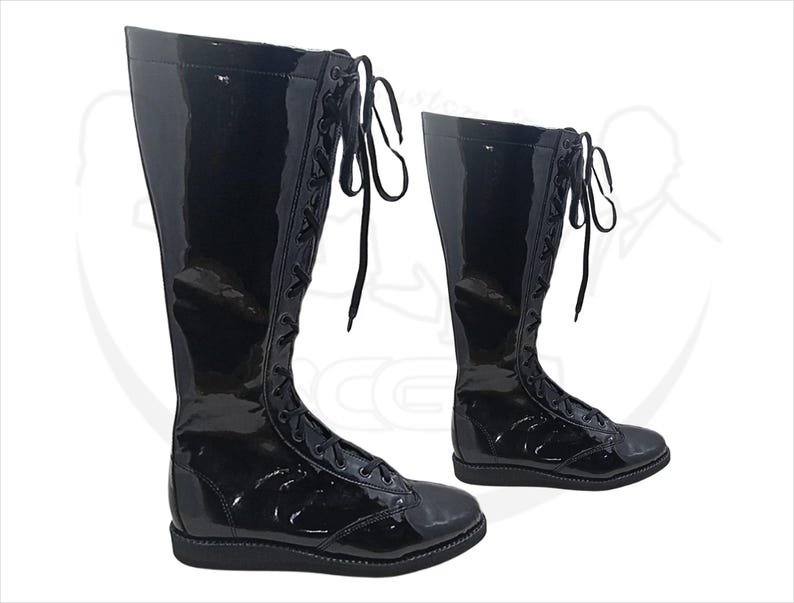May include: Two black, knee-high, lace-up boots with a glossy finish. The boots have a flat sole and a rounded toe. The laces are black and run up the front of the boots. The boots are displayed on a white background.