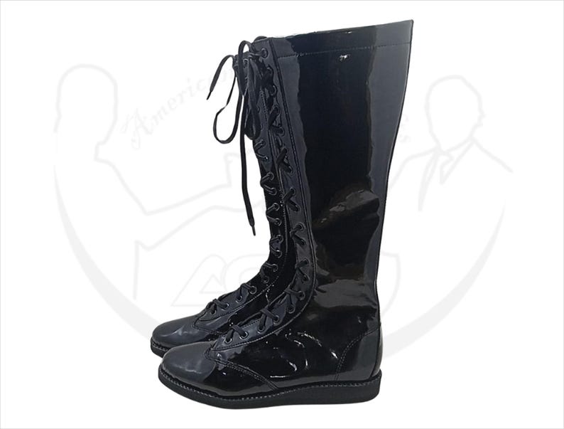 May include: A pair of black, knee-high boots with a glossy patent leather finish. The boots feature a lace-up design with black laces and a rounded toe. The boots are designed for a sleek, polished look.