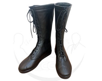 May include: A pair of black leather knee-high boots. The boots feature a lace-up design with black laces and a rounded toe. The boots are designed for a comfortable fit and are suitable for various occasions.