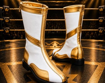 May include: A pair of mid-calf boots featuring a white base with metallic gold panels and trim. The boots have a vertical gold stripe running up the front, a gold collar, and a black sole. A zipper is visible on the back of each boot shaft.