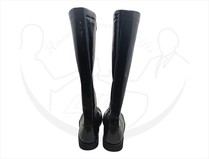 May include: A pair of black knee-high boots with a glossy patent leather finish. The boots have a sleek, streamlined design with a flat sole and a zipper detail on the side. The boots are displayed against a white background.