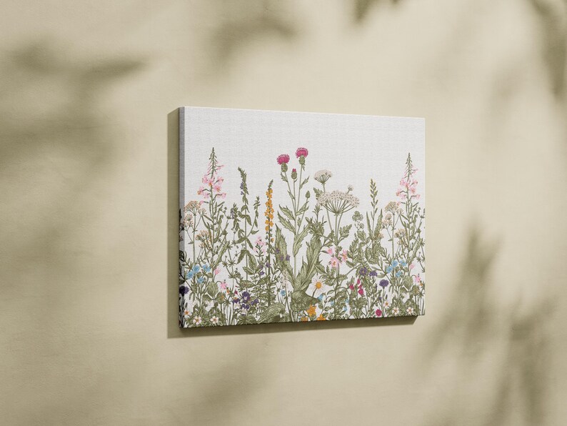 May include: A canvas print featuring a colourful floral design with a variety of flowers and plants, including pink, purple, yellow, and blue flowers.