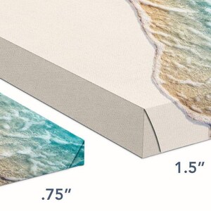 May include: Two canvas prints of a beach scene with ocean waves and sand. The smaller print is 0.75 inches thick and the larger print is 1.5 inches thick.