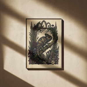 May include: A framed art print depicting a detailed illustration of a chameleon on a branch, framed by a gothic archway. The artwork uses greens, browns, and purples, with botanical elements and a compass. The print has a vintage aesthetic.