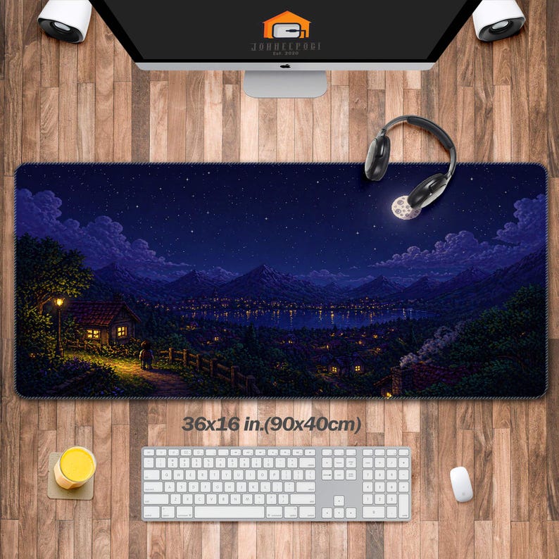 May include: A rectangular desk mat with a pixelated night scene featuring a starry sky, mountains, and a town with lights. The mat measures 36x16 inches (90x40cm). A keyboard, mouse, and headphones are visible.