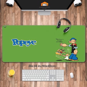 May include: A green Popeye mousepad with a cartoon image of Popeye and the text "Popeye". The mousepad is 36 x 16 inches (90 x 40 cm) and features a cartoon image of Popeye.