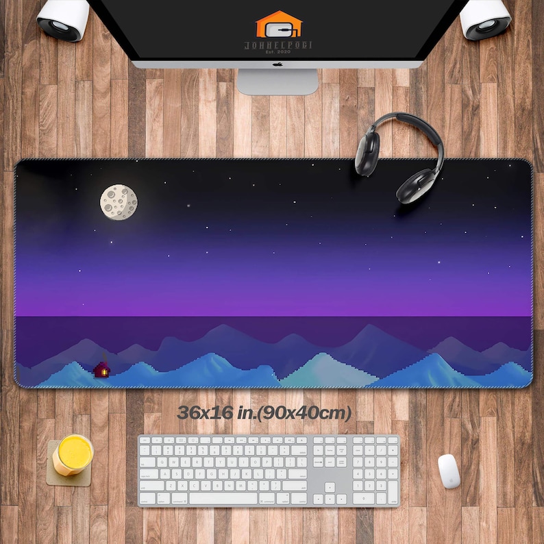 May include: A rectangular mouse pad with a pixelated night sky design, featuring a moon, stars, and mountains. The pad measures 36x16 inches. The text "36x16 in.(90x40cm)" is printed on the pad.