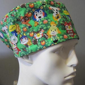 May include: Green scrub hat with a colorful print of various animal characters from the Animal Crossing video game series.
