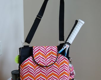 Large Tennis Bag with Rounded pockets and piping. Black with pink/orange and white print.