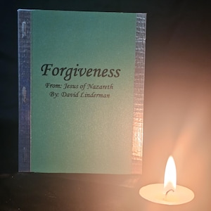 May include: A small, green book titled "Forgiveness" with text from Jesus of Nazareth, by David Linderman. The book is next to a lit candle, casting a warm glow.