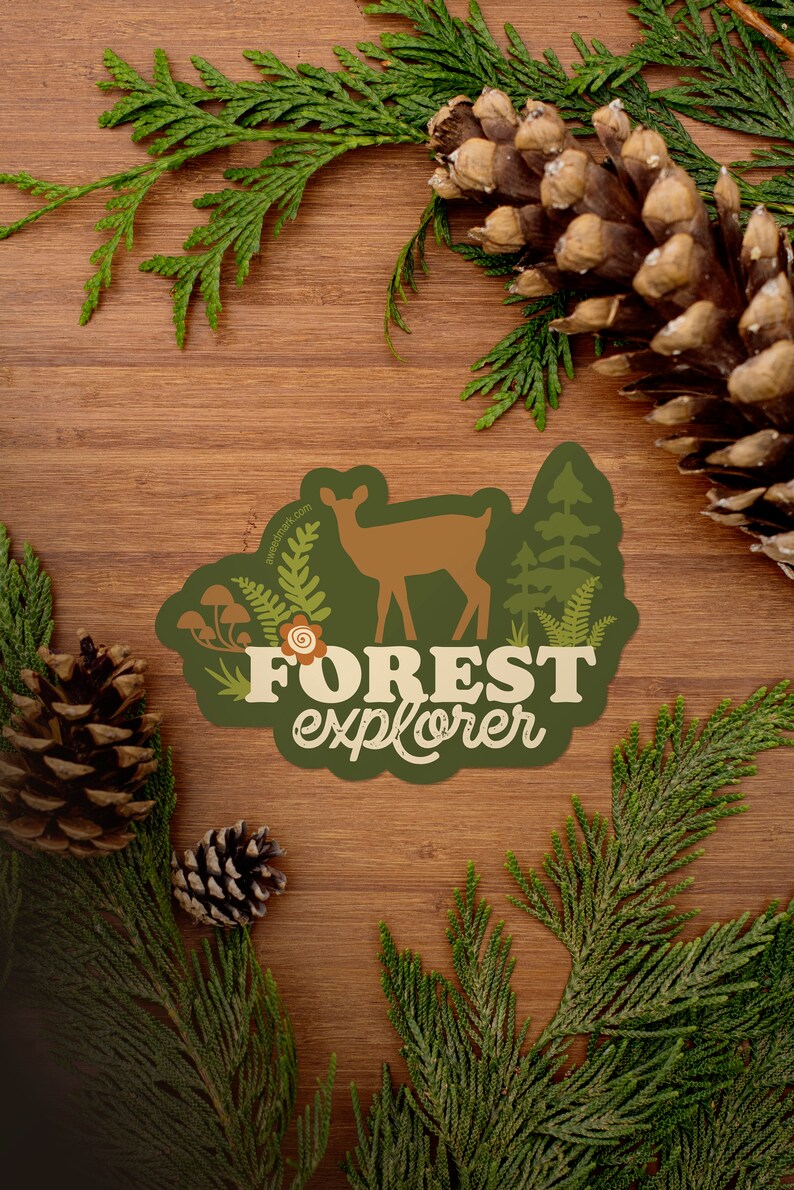 May include: A green sticker with a brown deer silhouette, green trees, and mushrooms. The text "FOREST explorer" is in white with a brown outline.