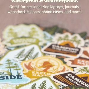 May include: A collection of waterproof and weatherproof stickers with outdoor and camping themes. The stickers feature illustrations of trees, mountains, and phrases like "Take me to the Trees" and "Camping is my therapy."
