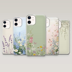 Peut inclure: Cinq coques de téléphone avec des motifs floraux. Les coques présentent divers arrangements floraux dans des tons de violet, bleu, rose, jaune et blanc sur un fond clair. Les coques sont en plastique transparent et ont une finition brillante.
