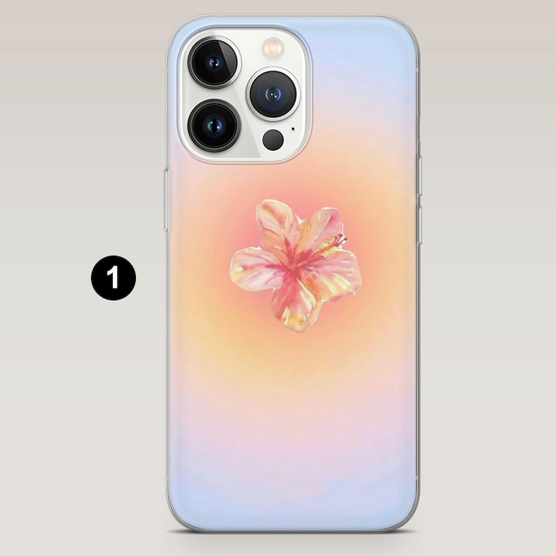 May include: A phone case with a watercolor design. The case features a gradient background of light blue, yellow, and pink hues. A detailed watercolor hibiscus flower is centered on the case. The case has a clear border and a camera cutout.