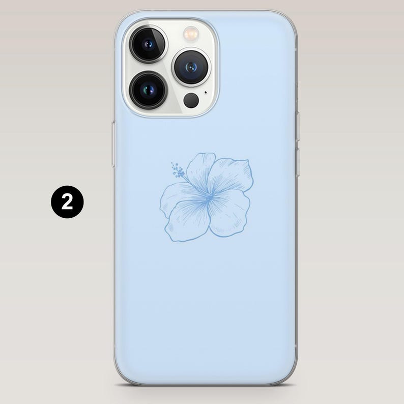 May include: A light blue phone case featuring a detailed, light blue hibiscus flower design. The case has a clear border and a camera cutout. The phone case is designed to fit a smartphone.