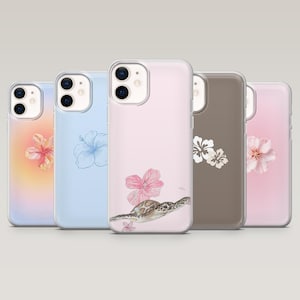 May include: Five clear phone cases with floral and sea turtle designs. The cases feature a variety of colors, including pink, blue, and brown. The designs include hibiscus flowers, a sea turtle, and other floral patterns.