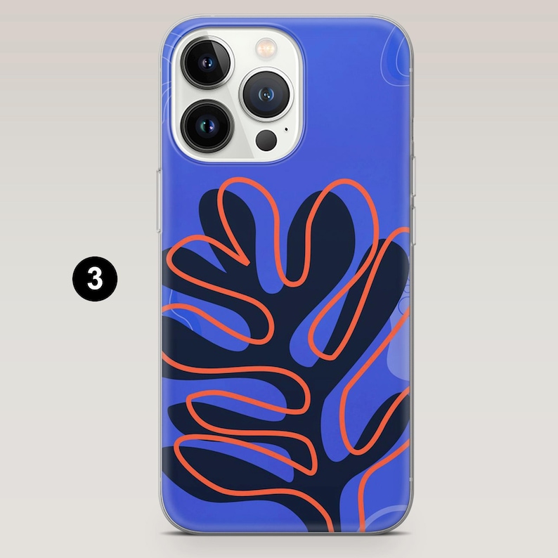 May include: A blue iPhone case with a dark blue and orange abstract design. The case has a clear border and features a three-lens camera cutout. The design includes a dark blue shape with orange outlines.