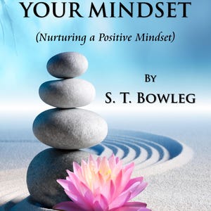 May include: Book cover with the title "Mastering Your Mindset" and the subtitle "Nurturing a Positive Mindset." The image features a stack of gray stones, a pink lotus flower, and the author's name, S. T. Bowleg.