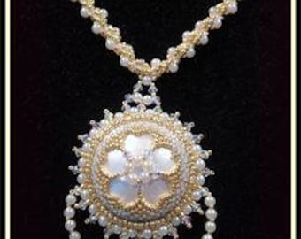 May include: A gold and white beaded necklace with a large, round pendant featuring a white flower design. The pendant has a small, clear crystal hanging from the bottom.