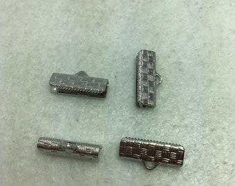May include: Four silver metal clasps for jewelry making. The clasps have a woven pattern and are designed to be used for necklaces, bracelets, or other jewelry projects.
