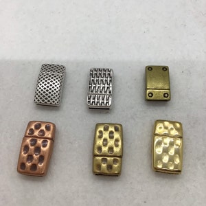 May include: Six different metal clasps for jewellery making. The clasps are silver, gold, and copper in colour. Each clasp has a different textured design.