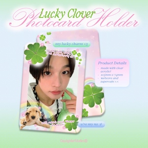 May include: A pink photocard holder with the text "Lucky Clover Holder" in a cursive font. The holder features a photo of a person and a puppy, with clover accents. The product details include dimensions of 105mm x 74mm.