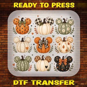 May include: A sheet of nine pumpkin-shaped graphics with mouse-like ears, featuring various patterns including hearts, plaid, flowers, polka dots, and leopard print, with bows on some, labeled READY TO PRESS DTF TRANSFER at the top and bottom.