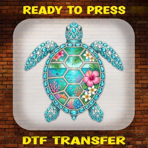 May include: A DTF transfer featuring a sea turtle illustration with a shell composed of hexagonal panels displaying an underwater ocean scene with coral, tropical flowers, and palm leaves, all outlined in blue and white gemstone textures.