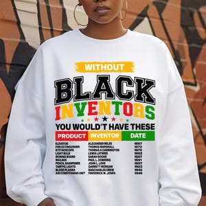 Peut inclure: Sweat-shirt blanc avec le texte "Without Black Inventors You Wouldn't Have These" en lettres noires. Un tableau liste les inventions et leurs inventeurs, notamment l'ascenseur, l'extincteur, le stéthoscope, l'ampoule électrique, la planche à repasser, la boîte aux lettres, le taille-crayon, les feux de circulation, le plasma sanguin et le climatiseur.