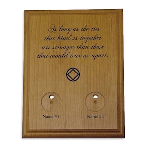 May include: Wooden plaque with engraved text: "As long as the ties that bind us together are stronger than those that would tear us apart." Features two circular cutouts and the text "Name #1" and "Name #2".
