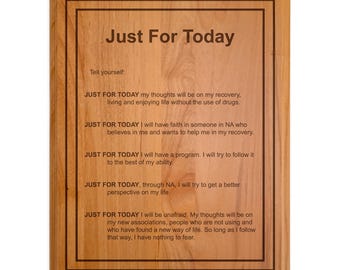 May include: A wooden plaque with the text "Just For Today" and a list of affirmations for daily living. The plaque is a light brown color with a dark brown border.