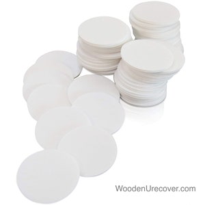May include: A stack of white round paper filters, perfect for coffee brewing or other filtering needs.  There are two stacks of filters, one with 20 filters and the other with 30 filters.