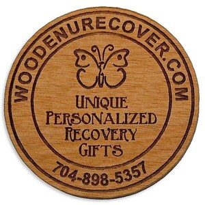 May include: Wooden round coaster with a butterfly design and the text "WOODENRECOVER.COM UNIQUE PERSONALIZED RECOVERY GIFTS 704-898-5357"