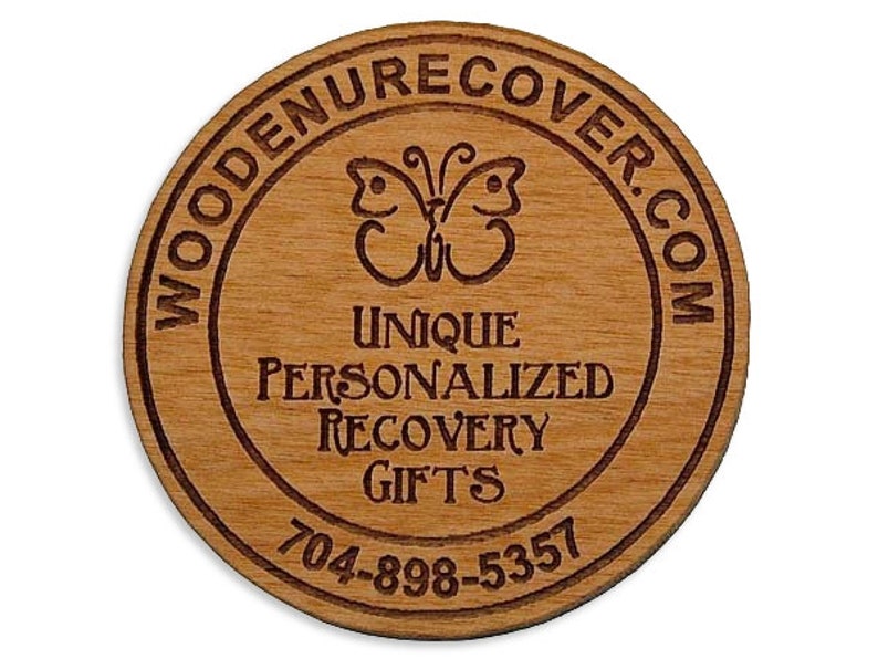 May include: Wooden round coaster with a butterfly design and the text "WOODENRECOVER.COM UNIQUE PERSONALIZED RECOVERY GIFTS 704-898-5357"