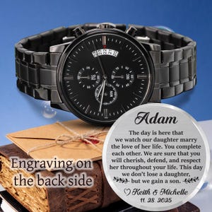 May include: A black chronograph watch with a matching black band. The watch face has multiple sub-dials and white markings. The watch is displayed with a personalized message that reads "Adam" and a heartfelt message.