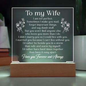 May include: A lighted acrylic plaque with the text "To my Wife" and a loving message, set on a wooden base. The message includes the phrases "I love you Forever and Always" and is decorated with floral accents.