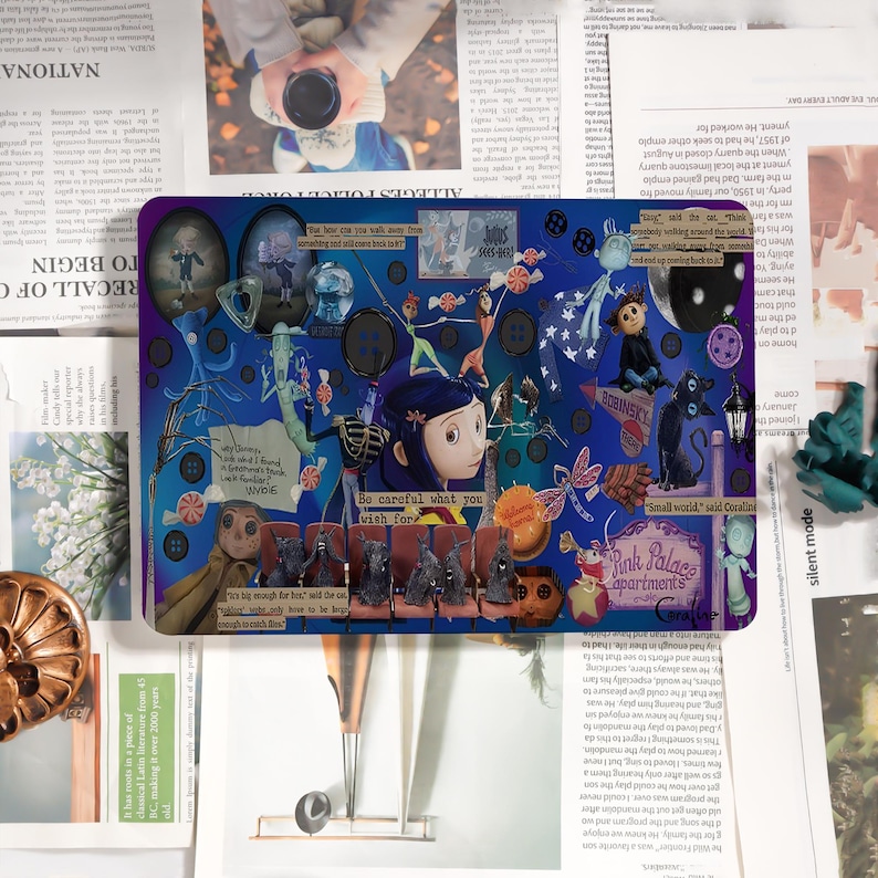 May include: A rectangular mousepad featuring a collage of illustrations and text from the movie "Coraline." The design includes characters, buttons, and the phrase "Be careful what you wish for." The color palette is primarily blue and purple.