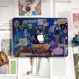 May include: A laptop skin featuring a collage of illustrations and text on a blue background. The design includes characters, buttons, and the text "Be careful what you wish for." An Apple logo is visible.