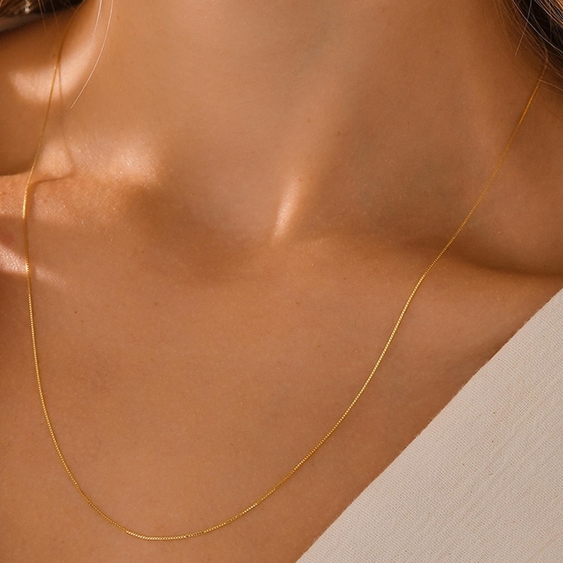 May include: A delicate gold chain necklace, ideal for layering or wearing alone.