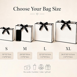 May include: Four white gift bags with black trim and bows, labeled S, M, L, and XL. The bags have dimensions in inches and centimeters. The image includes the text "Choose Your Bag Size" and icons for cards, a tumbler, a robe, and a gift set.